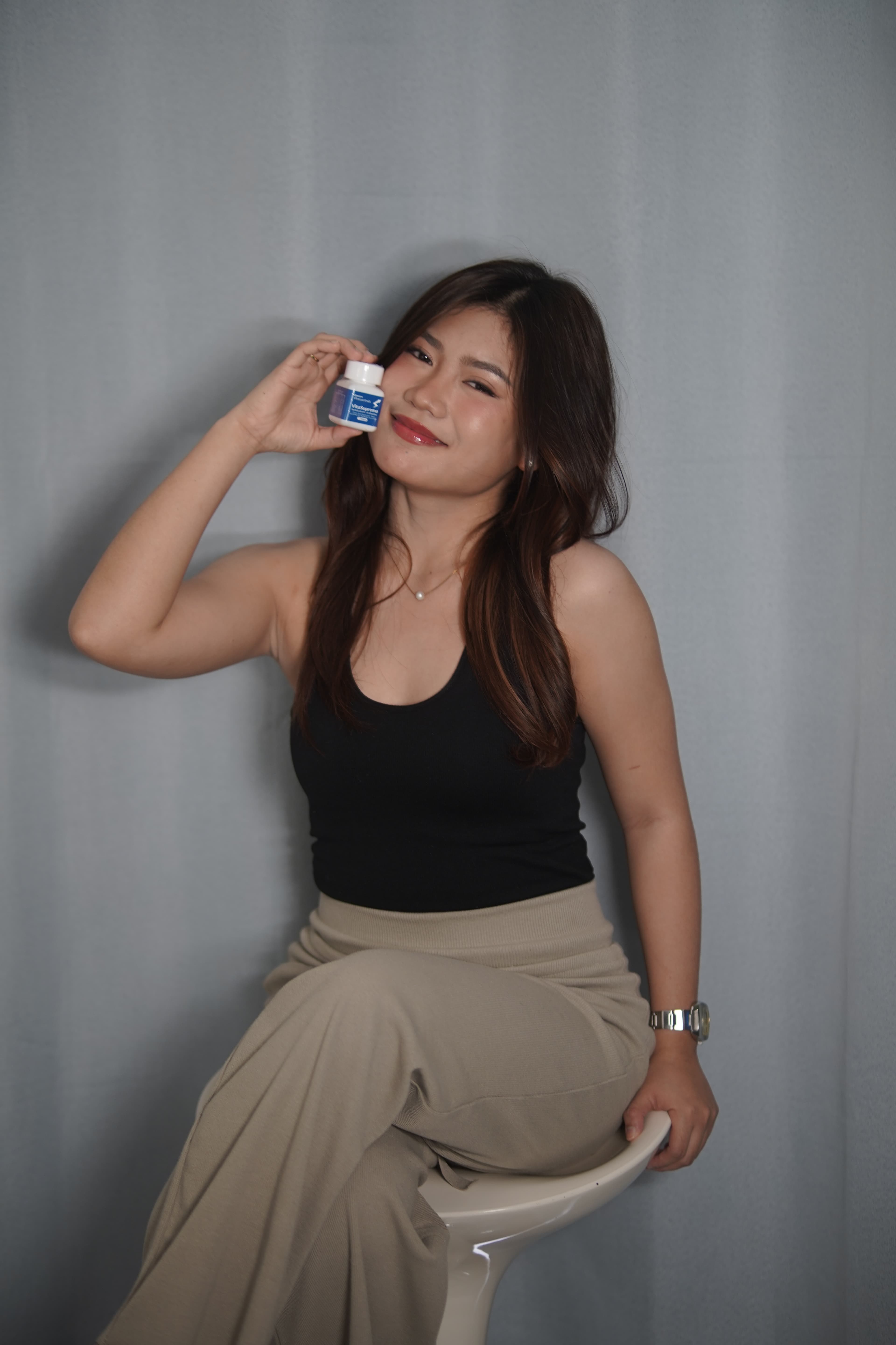 Smiling partner showcasing VitaSupremo dietary supplement